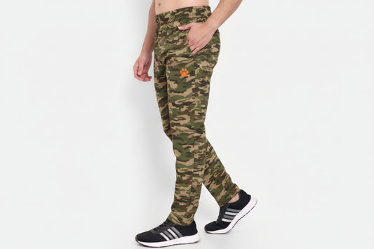 Person wearing green athletic pants with a brand logo on a white background