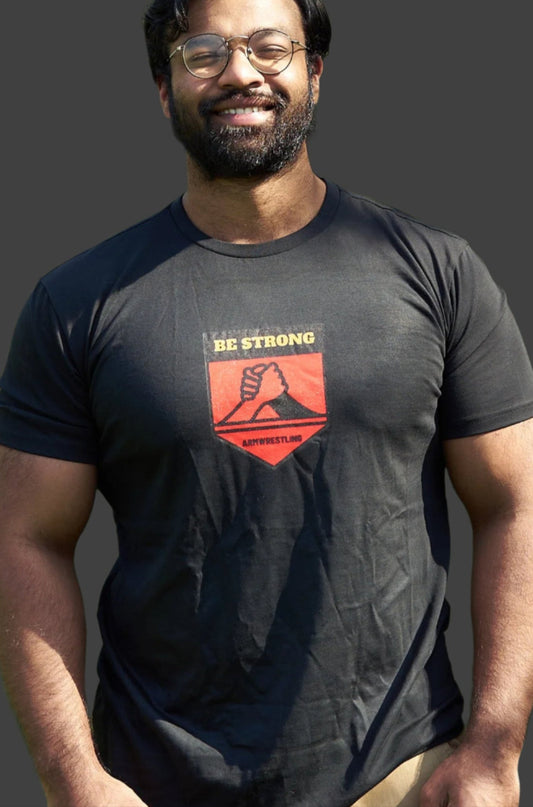 Man wearing a black t-shirt with a graphic design outdoors