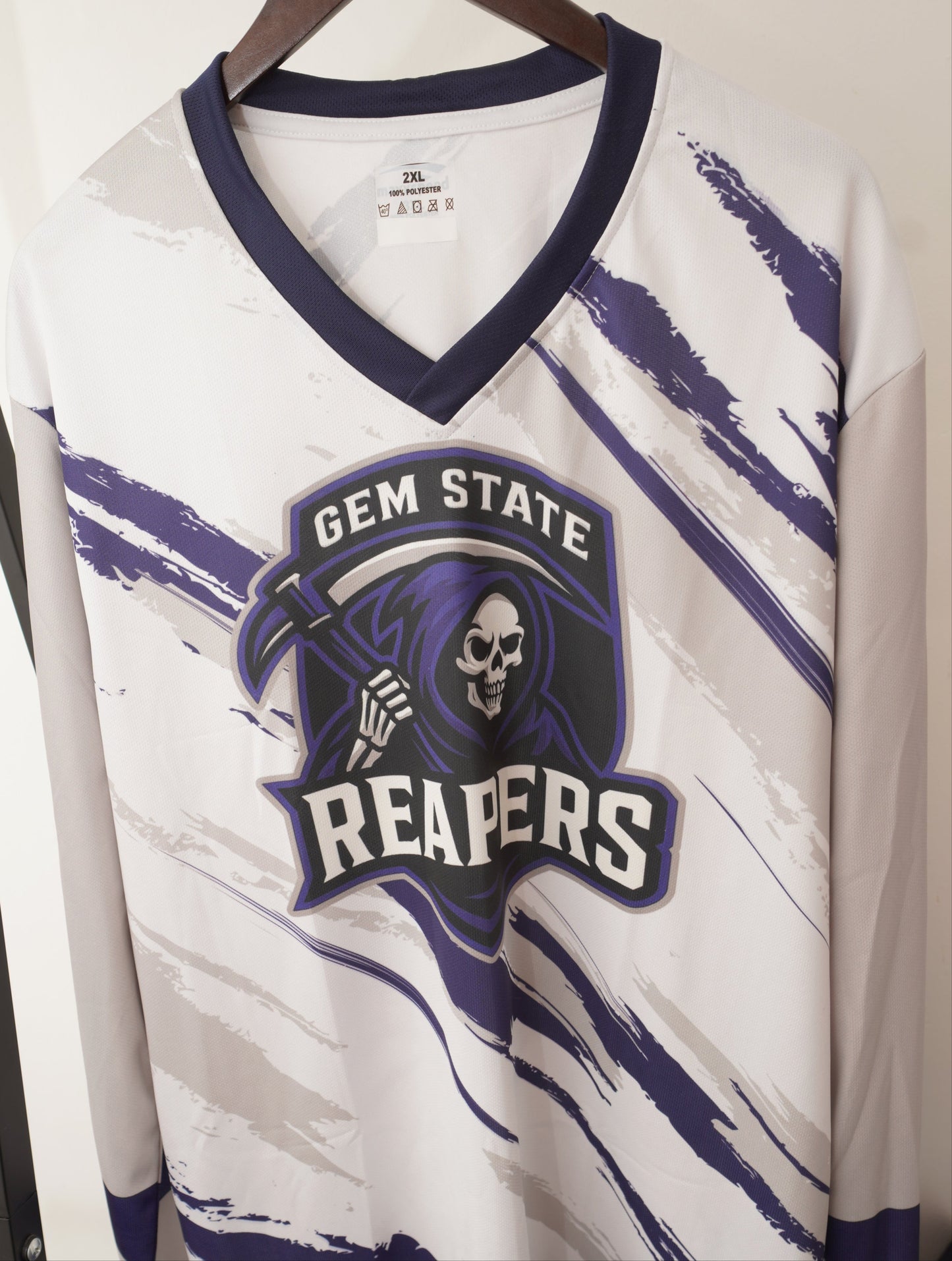 White sports jersey with purple and black text and graphics on a white background
