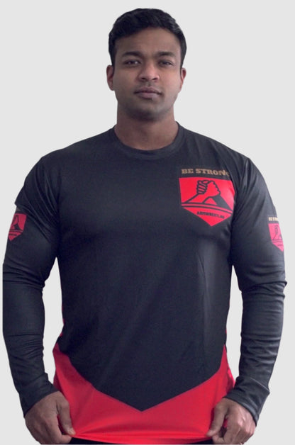 Person wearing a black and red athletic shirt with a logo on a plain background